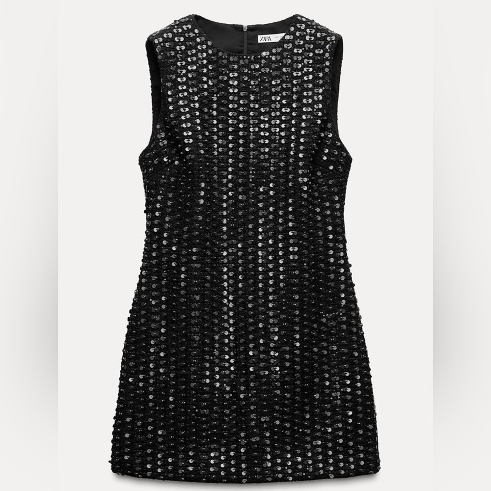 Round neck sleeveless mini dress. Sequin appliqué. Invisible back zip closure.